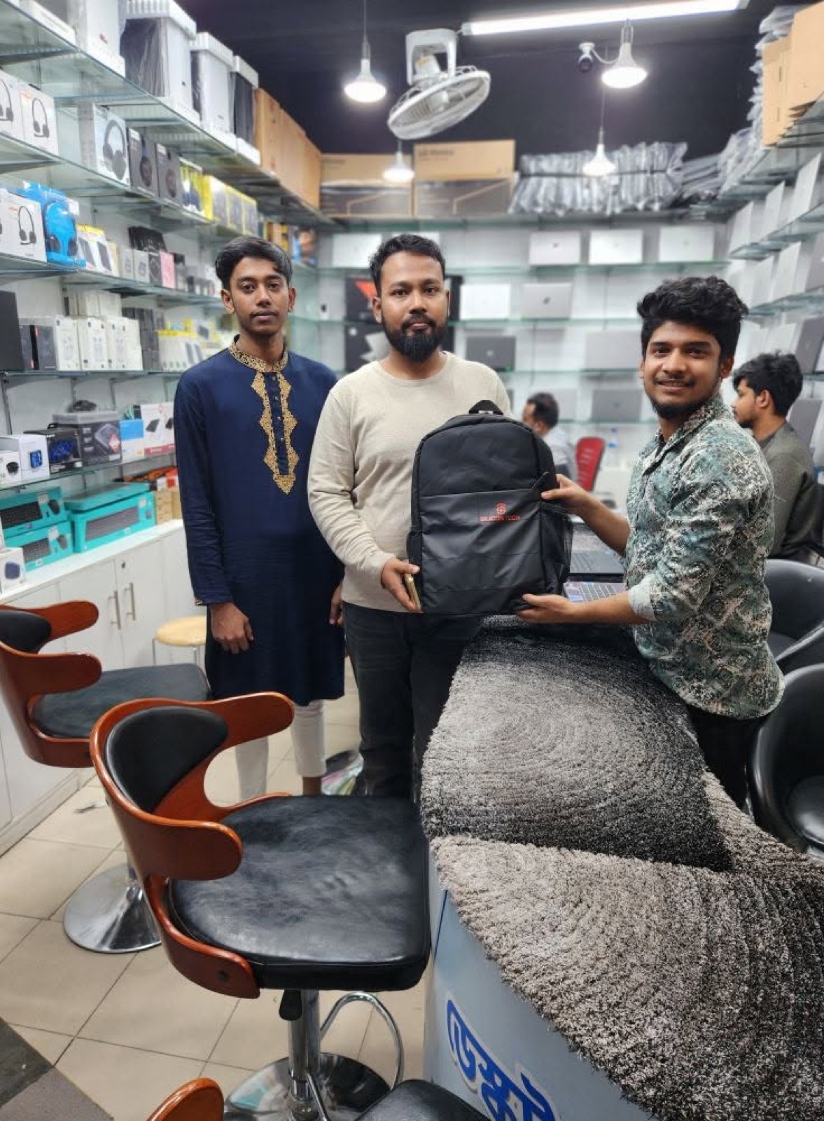 Customer receiving a Silicon Tech backpack in the showroom