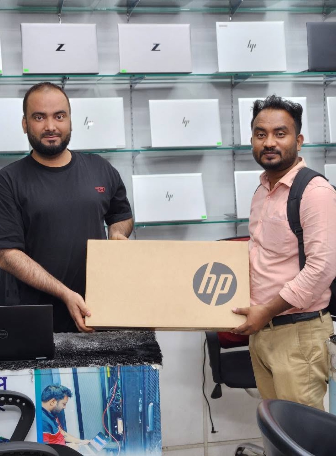 Customer collecting a boxed HP laptop from Silicon Tech